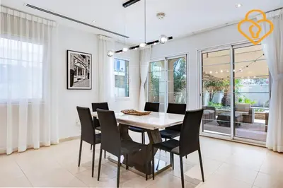 a dining room with a white table and chairs at Keysplease Amazing 2 B/R Villa With private Pool, JVT in Dubai