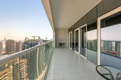an apartment balcony with chairs and a view of a city at Reva Hotel Apartment Downtown in Dubai