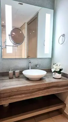 a bathroom with a sink and a large mirror at Amazing Paramount Hotel apartment D48 in Dubai