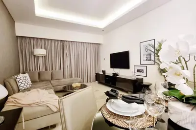 a living room with a couch and a table at Amazing Paramount Hotel apartment D48 in Dubai
