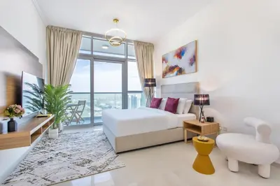 a bedroom with a bed and a large window at Full Golf View Studio in Damac Hills - Host & Stay in Dubai