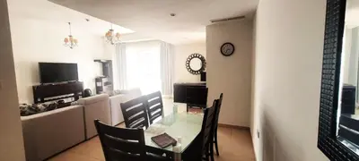 a living room with a table and chairs and a couch at 2BR Jumeirah Beach front Residence in Dubai