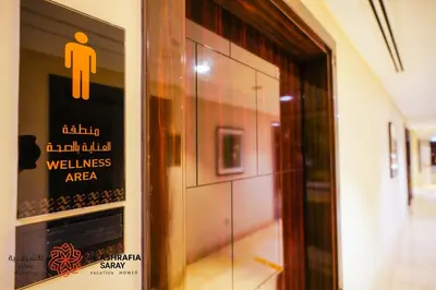 a door with a sign for a restroom in a building at Alashrafia Saray - Fabulous 1BR in Canal Views in Dubai