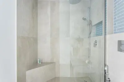 a bathroom with a shower with a glass door at Frank Porter - Al Ghozlan 4 in Dubai