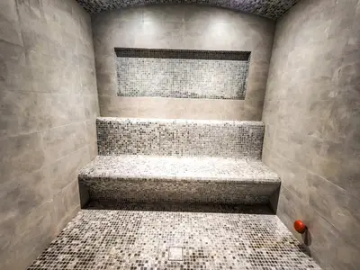 a bathroom with a shower with a tiled wall at STAY BY LATINEM Luxury 1BR Holiday Home G61024 near Burj Khalifa in Dubai