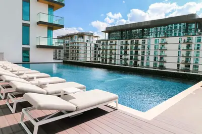 a swimming pool with lounge chairs on a building at STAY BY LATINEM Luxury 1BR Holiday Home G61024 near Burj Khalifa in Dubai