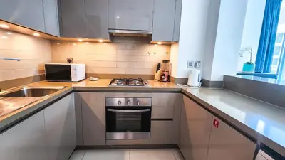 a small kitchen with a stove and a sink at STAY BY LATINEM Luxury 1BR Holiday Home G61024 near Burj Khalifa in Dubai