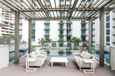 a patio with couches and a table on a building at STAY BY LATINEM Luxury 1BR Holiday Home G61024 near Burj Khalifa in Dubai