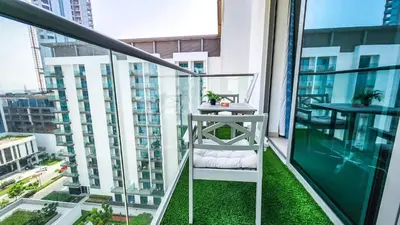 a balcony with a white ladder and green grass at STAY BY LATINEM Luxury 1BR Holiday Home G61024 near Burj Khalifa in Dubai