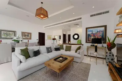 a living room with a couch and a coffee table at Maison Privee - Splendid Apt on The Palm with Stunning Sea Views in Dubai