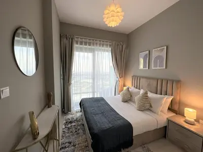a bedroom with a bed and a large window at EasyGo - Affordable 1br Close to Public Transit - Zad-13 in Dubai