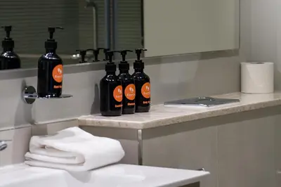 a bathroom with a group of bottles on a counter at EasyGo - Affordable 1br Close to Public Transit - Zad-13 in Dubai