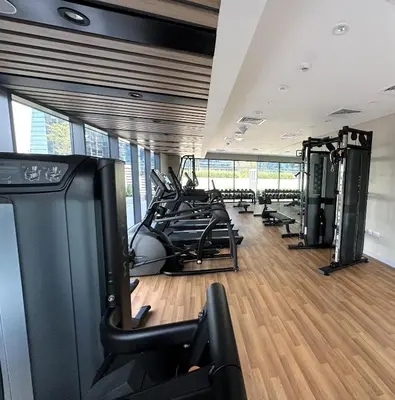 a gym with treadmills and cardio equipment in a room at EasyGo - Affordable 1br Close to Public Transit - Zad-13 in Dubai
