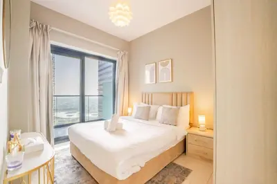 a bedroom with a bed and a large window at EasyGo - Affordable 1br Close to Public Transit - Zad-13 in Dubai