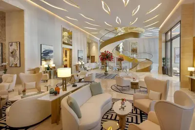 a lobby of a hotel with couches and chairs at LHG PALM JUMEIRAH Tallest RoofTop Pool in Dubai