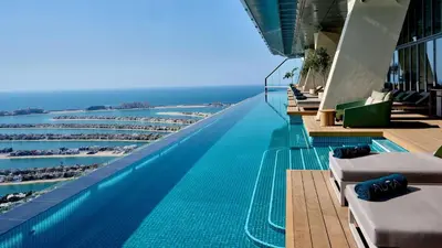a swimming pool on a building with a view of the ocean at LHG PALM JUMEIRAH Tallest RoofTop Pool in Dubai