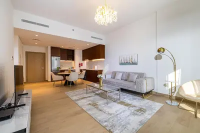 a living room with a couch and a table at Apartment with Partial Sea View in La Mer in Dubai