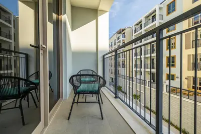 a balcony with chairs and a view of buildings at Apartment with Partial Sea View in La Mer in Dubai