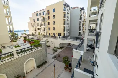an apartment balcony with a view of a courtyard at Apartment with Partial Sea View in La Mer in Dubai