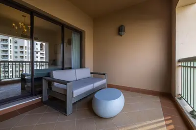 a living room with a bench and a table at Apartment in Golden Mile with access to Fairmont in Dubai