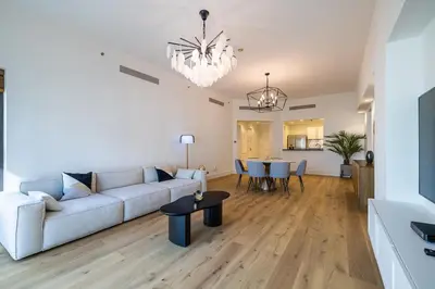 a living room with a couch and a table at Apartment in Golden Mile with access to Fairmont in Dubai