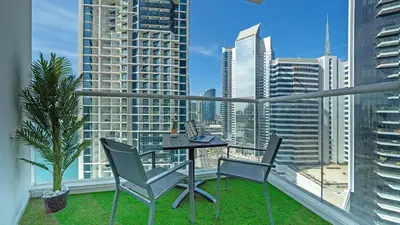 a balcony with a table and chairs and a view of a city at Bright Deluxe Studio canal view - Special offer in Dubai