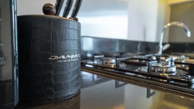a black tire sitting on a counter next to an oven at Bright Deluxe Studio canal view - Special offer in Dubai