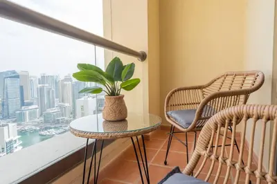 a room with a table and two chairs and a window at Dominant View of Dubai Marina in Dubai
