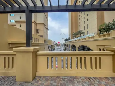 a balcony of a building with a fence and a street at Dominant View of Dubai Marina in Dubai