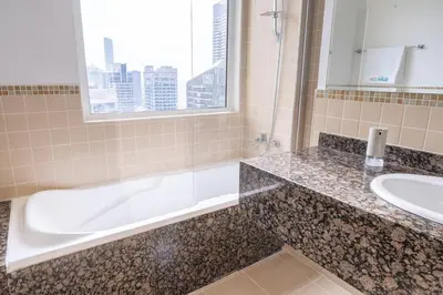 a bathroom with a bath tub and a sink at Dominant View of Dubai Marina in Dubai