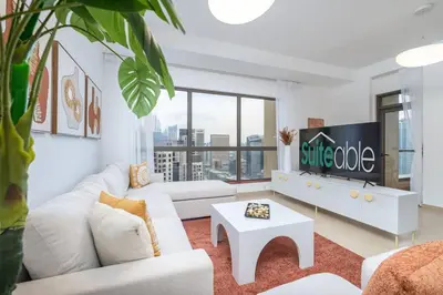 a living room with white furniture and a large window at Dominant View of Dubai Marina in Dubai