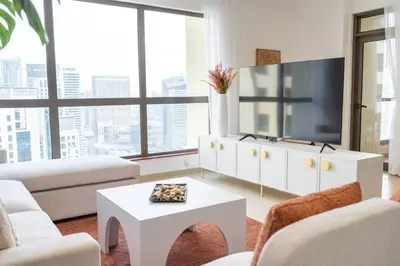a living room with a tv and a white coffee table at Dominant View of Dubai Marina in Dubai