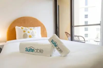 a white bed with two pillows on top of it at Dominant View of Dubai Marina in Dubai