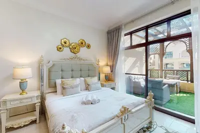 a white bedroom with a large bed and a window at Al Tajer, Core C, Souk Al Bahar - Charming Two Bedroom in Dubai