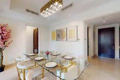 a dining room with a glass table and chairs at Al Tajer, Core C, Souk Al Bahar - Charming Two Bedroom in Dubai