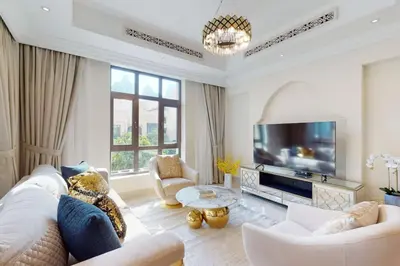 a living room with a couch and a tv at Al Tajer, Core C, Souk Al Bahar - Charming Two Bedroom in Dubai