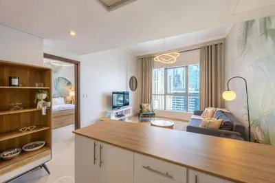 a living room with a table and a couch at Bay Central, Dubai Marina - Exquisite One Bed with Marina View in Dubai