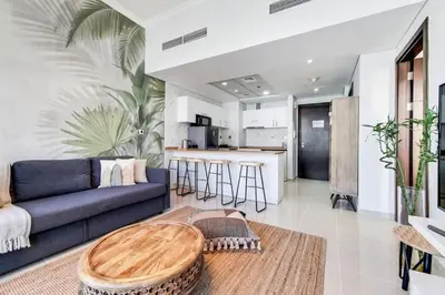 a living room with a blue couch and a table at Bay Central, Dubai Marina - Exquisite One Bed with Marina View in Dubai