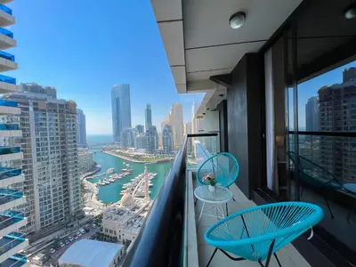 a balcony with two chairs and a view of a harbor at Charming 1BR Apart With Stunning Sea&Marina Views in Dubai