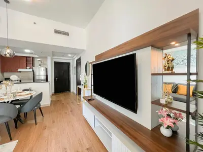 a living room with a large flat screen tv on a wall at Charming 1BR Apart With Stunning Sea&Marina Views in Dubai