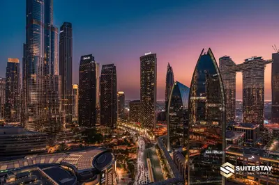 a city skyline with tall buildings at dusk at Suitestay Address Dubai Mall Residence in Dubai