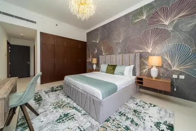 a bedroom with a large bed and a chandelier at Amazing BeachFront Apartments near Atlantis Waterpark by Simply Comfort Sarai Palm Jumeirah in Dubai