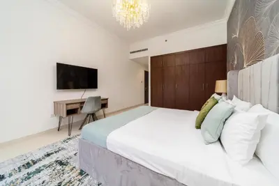 a bedroom with a large white bed and a desk at Amazing BeachFront Apartments near Atlantis Waterpark by Simply Comfort Sarai Palm Jumeirah in Dubai