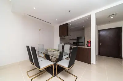 a dining room with a glass table and chairs at Amazing BeachFront Apartments near Atlantis Waterpark by Simply Comfort Sarai Palm Jumeirah in Dubai