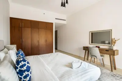 a bedroom with a bed and a desk and a television at Amazing BeachFront Apartments near Atlantis Waterpark by Simply Comfort Sarai Palm Jumeirah in Dubai