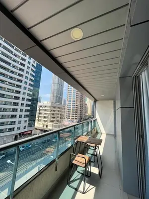 a balcony with two tables and chairs on a building at Elegant stay at marina Dubai in Dubai