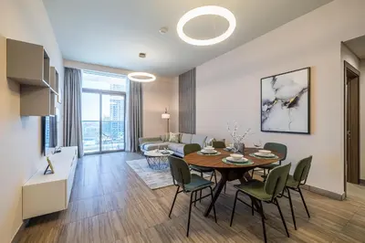 a dining room and living room with a table and chairs at MBL I Modern 2 Bedroom Apartment in JLT in Dubai