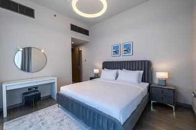 a bedroom with a large bed and a mirror at MBL I Modern 2 Bedroom Apartment in JLT in Dubai