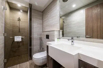 a bathroom with a sink and a toilet and a mirror at MBL I Modern 2 Bedroom Apartment in JLT in Dubai