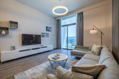 a living room with a couch and a tv at MBL I Modern 2 Bedroom Apartment in JLT in Dubai
